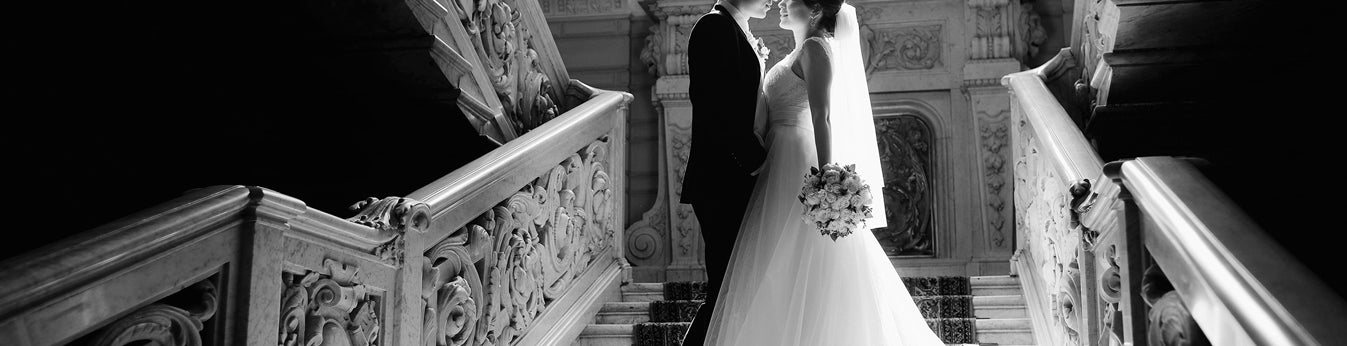 Groom and bride on a marble stairwell